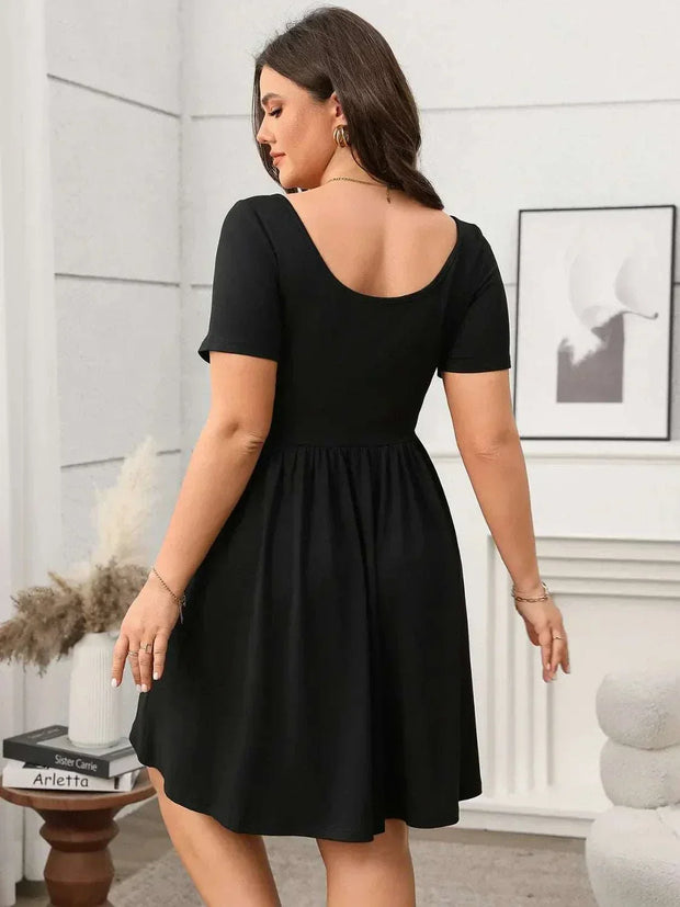 Plus size black square-neck short-sleeve mini dress, perfect for stylish comfort.