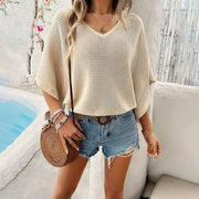 V-Neck Bat Sleeve T-shirt in beige, casual chic style with comfortable batwing sleeves, paired with denim shorts and accessories.