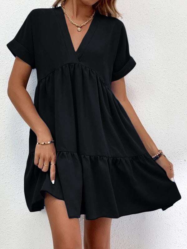 Short-sleeved V-neck dress in black, featuring a flowy skirt and casual chic style.