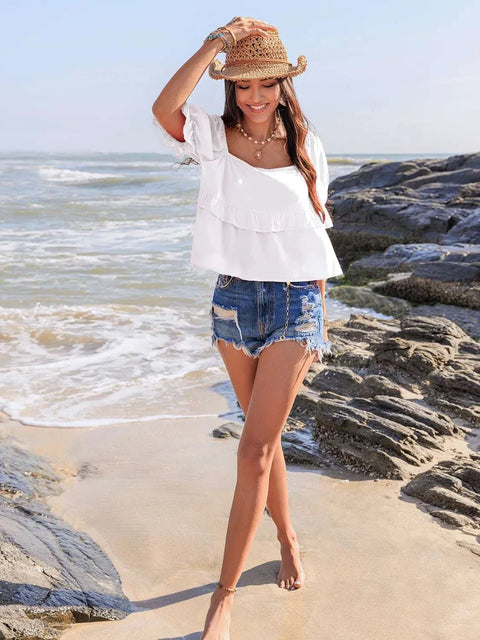 Ruffled square neck half sleeve blouse on woman at beach.