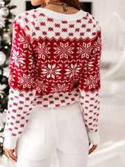 Red and white snowflake pattern long sleeve sweater worn by woman