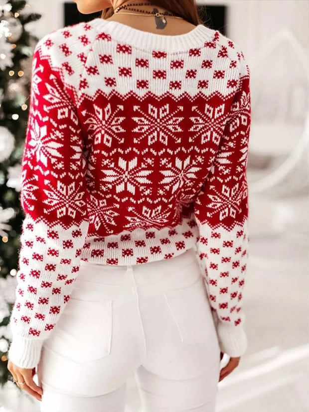 Red and white snowflake pattern long sleeve sweater worn by woman