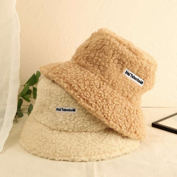 Lambswool Female Fishing Cap in beige and cream colors, stylish and cozy for outdoor activities.