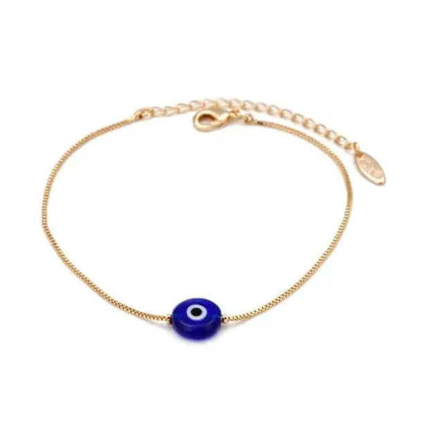 Charm bracelet with blue eye charm on a gold chain, featuring an adjustable clasp.
