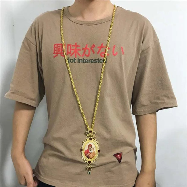 Orthodox Jesus Cross Pendant with intricate design worn on a gold chain.
