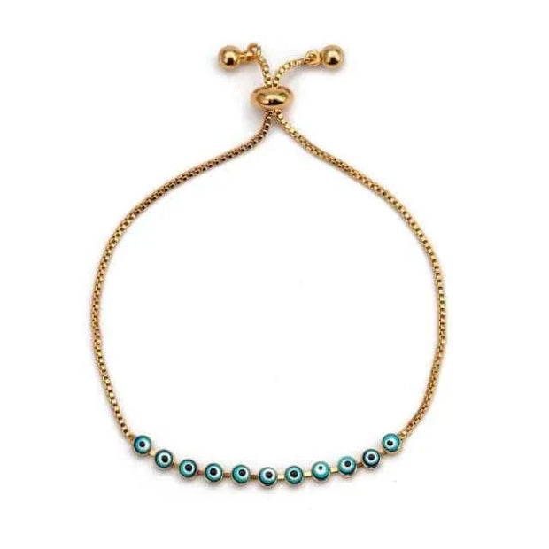 Elegant charm bracelet with turquoise evil eye beads on a gold chain, perfect for self-expression.