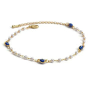 Delicate charm bracelet with blue and white beads, gold accents, and a secure clasp.