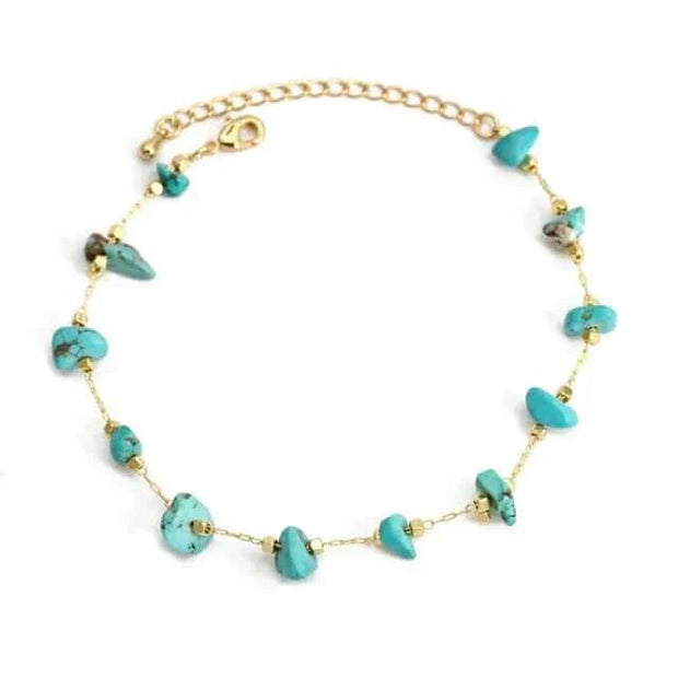 Turquoise charm bracelet with gold chain and secure clasp for self-expression.