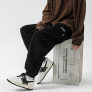 Black straight-leg sweatpants with elastic waistband and adjustable drawstring for comfort and style.