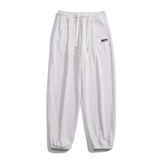 Milky white straight-leg sweatpants with elastic waistband and adjustable drawstring, ideal for casual wear.