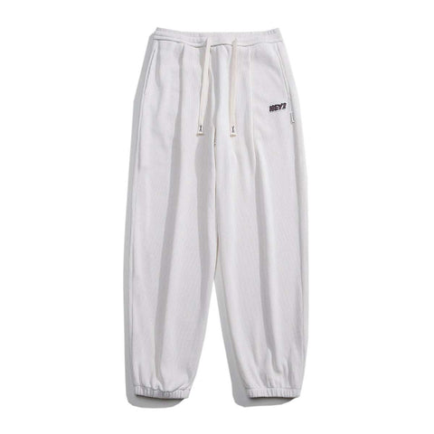 Milky white straight-leg sweatpants with elastic waistband and adjustable drawstring, ideal for casual wear.