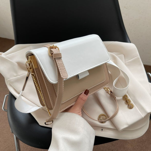 Square Chain Shoulder Bag with white and beige color, featuring a stylish chain strap, placed on a black chair.