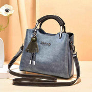 Small Retro Handbag in light blue with shoulder strap and handle, vintage design, PU material.