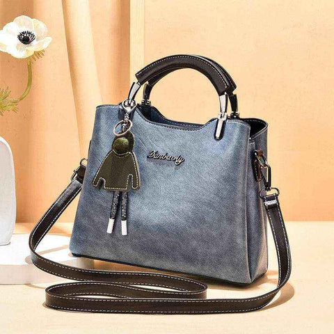 Small Retro Handbag in light blue with shoulder strap and handle, vintage design, PU material.