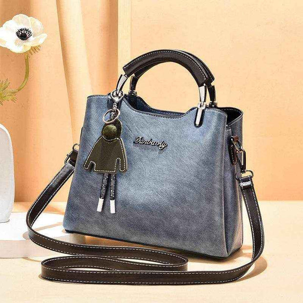 Small Retro Handbag in light blue with shoulder strap and handle, vintage design, PU material.