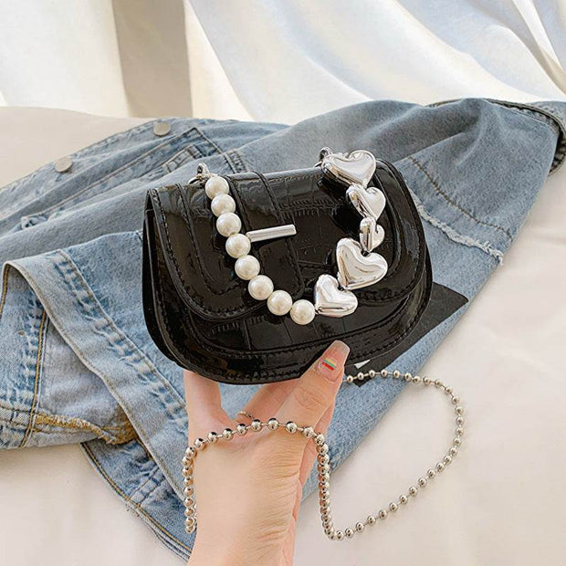 Laser Pearl Girl Tote with laser-cut design and pearl finish, stylish crossbody bag on denim background.