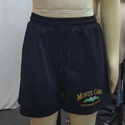 Black printed casual shorts with elastic waistband and vibrant design, perfect for summer comfort and style.