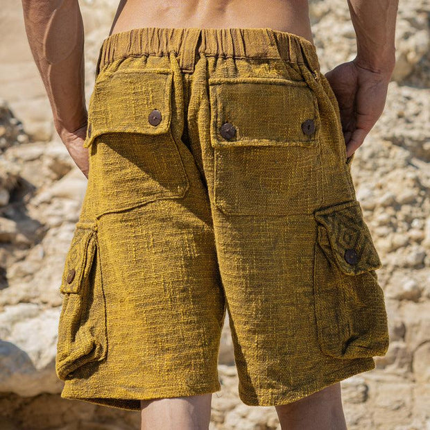 Mens casual linen shorts with pocket design in a natural outdoor setting.