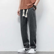 Washed wide leg jeans in dark gray, featuring high-quality denim and a relaxed fit.