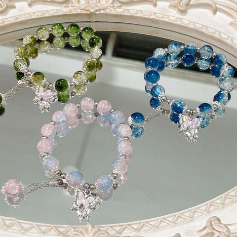 Fairy Beads Butterfly Bracelet with colorful glass beads and butterfly charms on a decorative mirror.