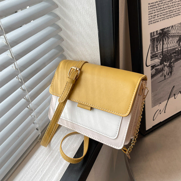 Square Chain Shoulder Bag with yellow and white design, featuring a stylish chain strap, displayed indoors.