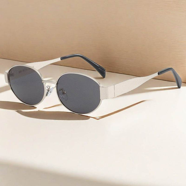 Contrast Womens Vintage Metal Oval Sunglasses with sleek design and tinted lenses on a neutral background.