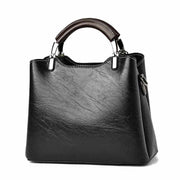 Black Small Retro Handbag with vintage design and top handle.