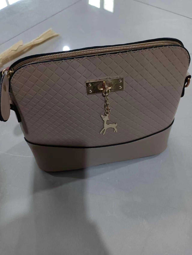 Womens Mini Portable Handbag with quilted design and deer charm, compact and stylish.
