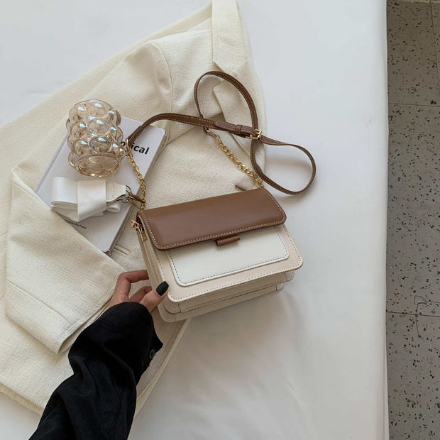 Square Chain Shoulder Bag with brown accents and elegant chain strap on white surface.