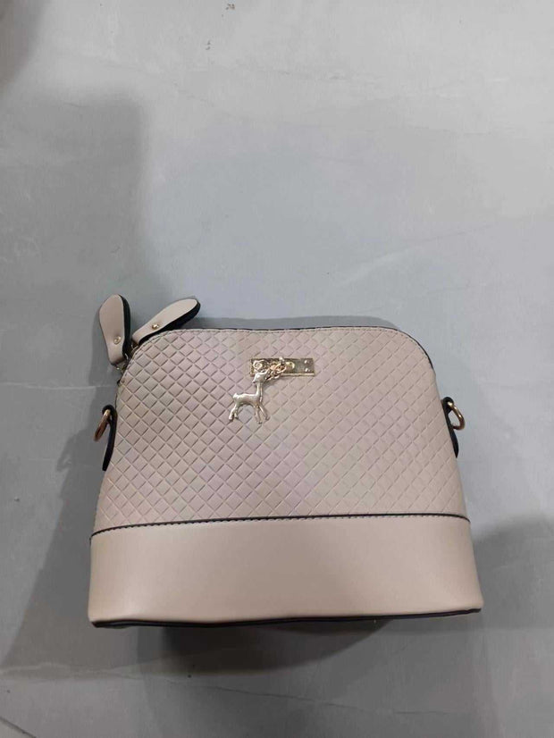 Womens Mini Portable Handbag with quilted design and gold accents on grey background.