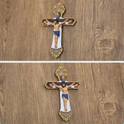 Religious Cross Wall Ornament with intricate design on wooden background.