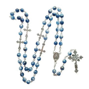Rosary necklace with blue beads and silver cross pendant, showcasing elegance and spirituality.