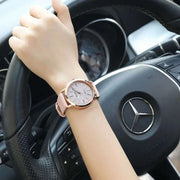Elegant Full Star Womens Watch on a woman's wrist while driving a car.