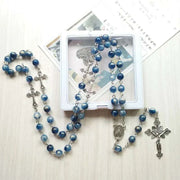 Elegant Rosary Necklace with blue beads and cross pendant for spiritual expression.