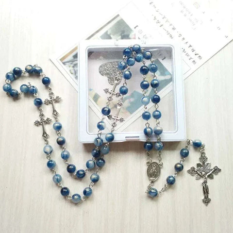 Elegant Rosary Necklace with blue beads and cross pendant for spiritual expression.