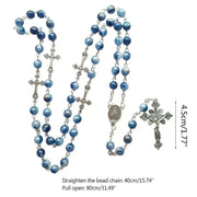 Rosary necklace with cross pendant featuring blue beads and crucifix design.