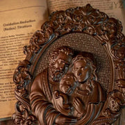 Religious Holy Family wooden icon with intricate carvings depicting Jesus, Mary, and Joseph.