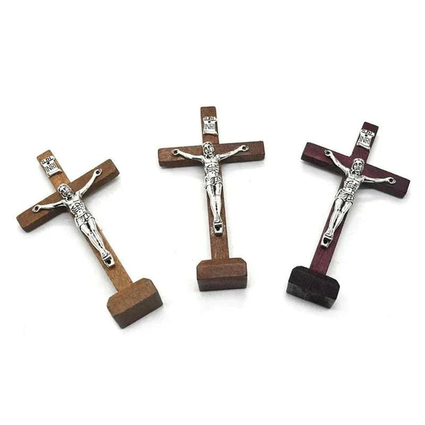 Wooden Jesus Cross with stand in various finishes: brown, light brown, and wine red.