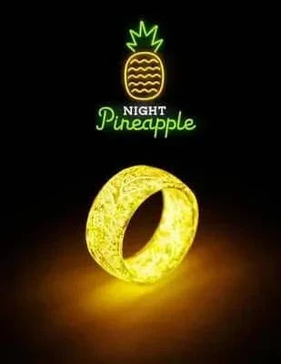 Unisex Luminous Ring glowing in the dark with a "Night Pineapple" logo above.