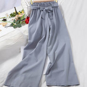 Wide leg elastic waist casual pants with bow, displayed in stylish setting.
