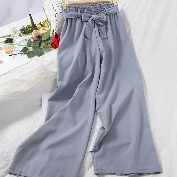 Wide leg elastic waist casual pants with bow, displayed in stylish setting.