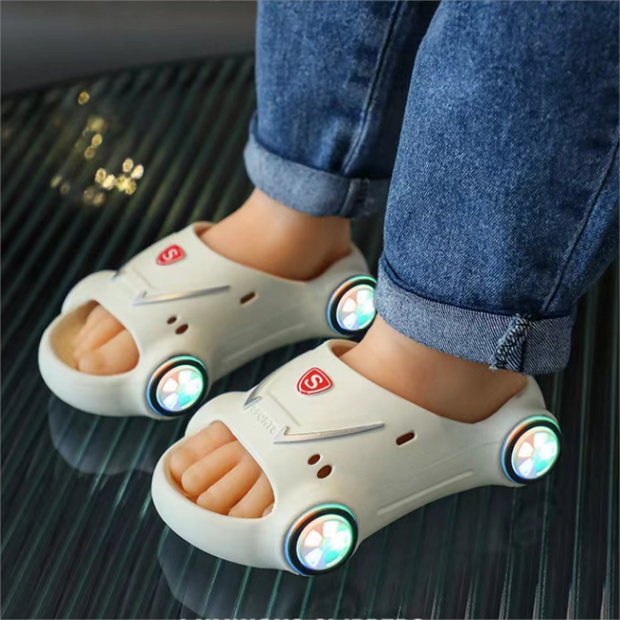 Kids wearing glowing LED slippers with sports car design, featuring non-slip soles for safety.