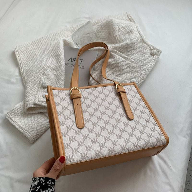Large capacity handbag with stylish design and leather straps.