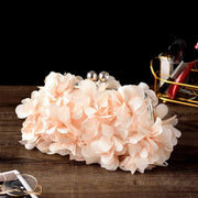 Elegant bridal clutch adorned with floral elements, perfect for weddings and special occasions.