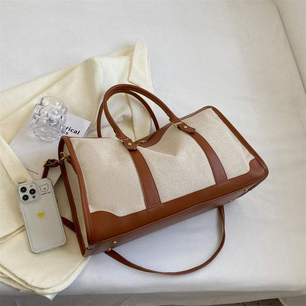 Elegant large capacity purse with brown leather accents and adjustable strap, designed for modern use.