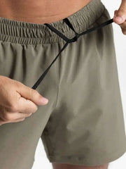 Men's elastic waist active shorts with adjustable fit in olive green.