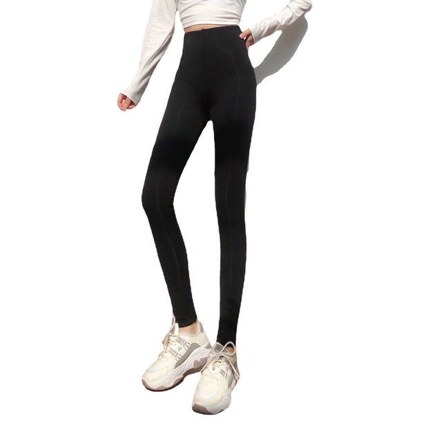 Black lambs wool leggings providing warmth and comfort with a high waistband, shown on a model in a white top.
