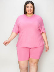 Plus size model wearing a pink Bae V-Neck T-Shirt and Shorts Set, showcasing comfort and casual chic style.