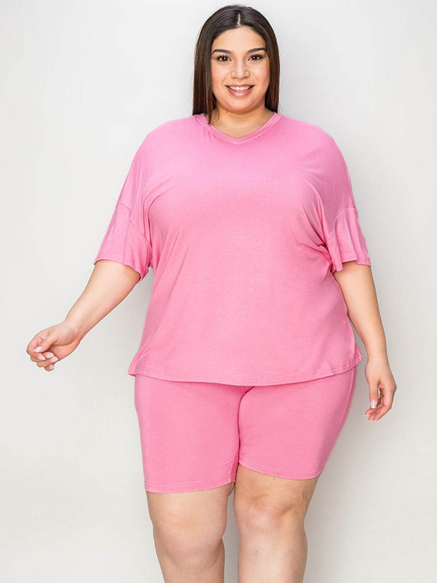 Plus size model wearing a pink Bae V-Neck T-Shirt and Shorts Set, showcasing comfort and casual chic style.