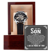 Openwork watch with black leather band in mahogany box, showcasing intricate mechanics and stylish design for son.